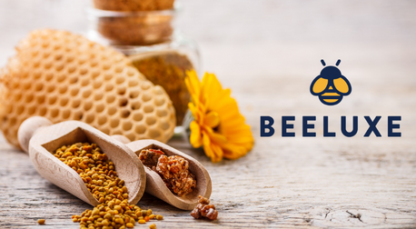 Natural honeycomb, bee pollen, and propolis on wood with Beeluxe logo