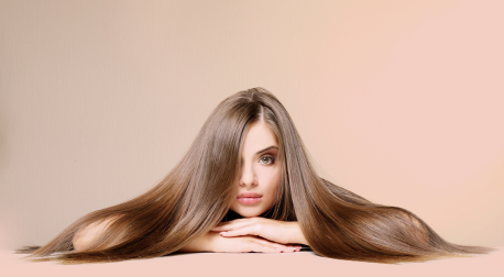 Woman with long, shiny brown hair representing healthy hair growth