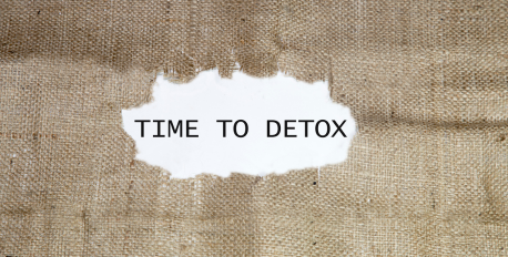 Time to Detox text revealed through a torn hole in brown burlap fabric
