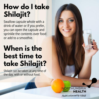 Smiling woman holding a glass of water next to instructions on how to take Shilajit capsules.