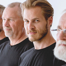 Five men of various ages wearing black shirts against a white background
