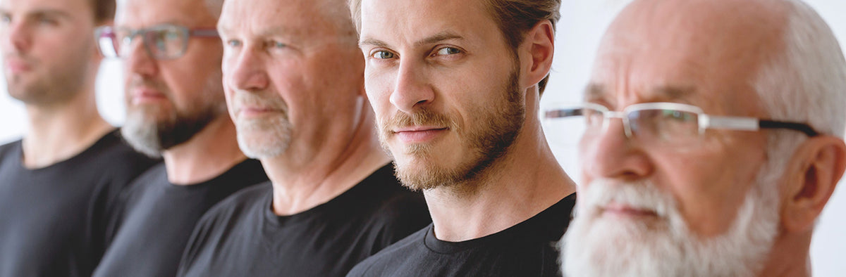 Five men with varying hairstyles and facial hair, wearing black shirts.
