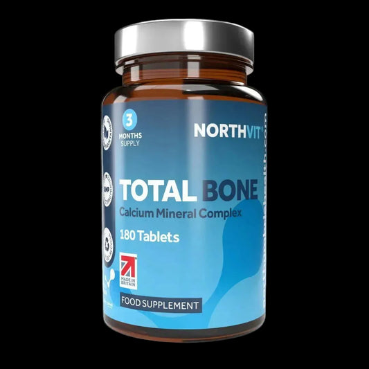 Northvit Total Bone Calcium Mineral Complex 180 tablets in an amber bottle with a blue label.