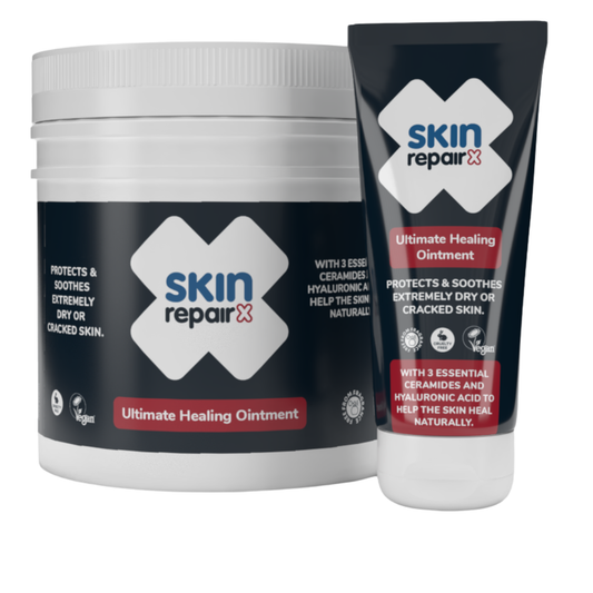 SkinRepairX Ultimate Healing Ointment in a white jar and black squeeze tube with blue and red branding on a white background.