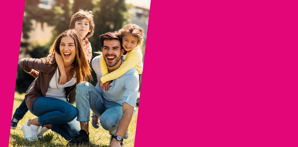 Family of four posing outdoors with a pink border