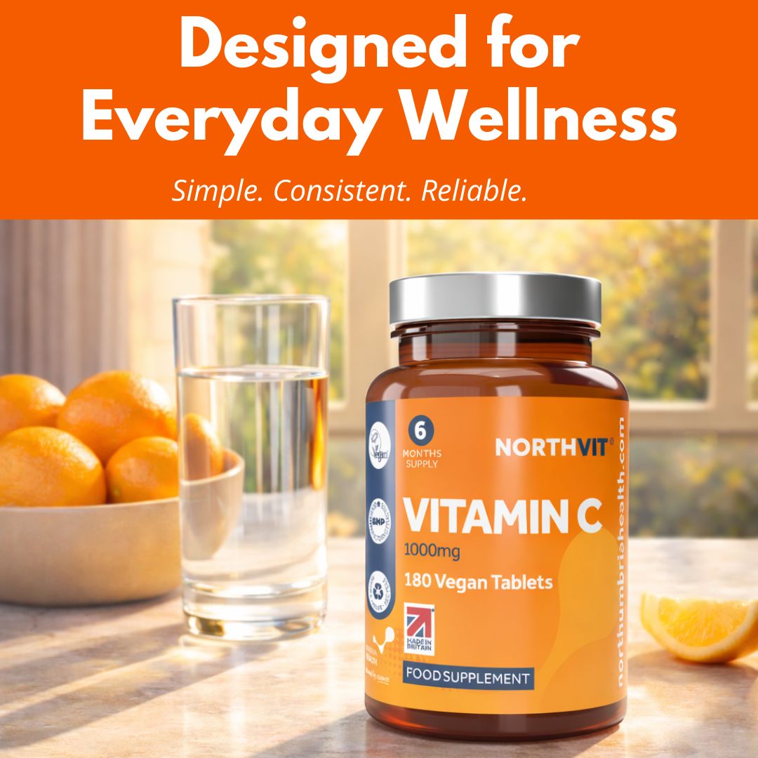 NorthVit Vitamin C 1000mg bottle next to a glass of water and fresh oranges.