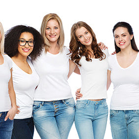 Group of women wearing white tops and blue jeans against a white background