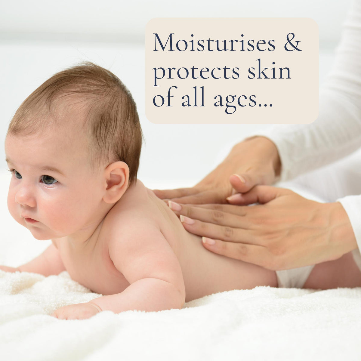 A mother gently massages Beeluxe natural skin balm onto her baby's back.